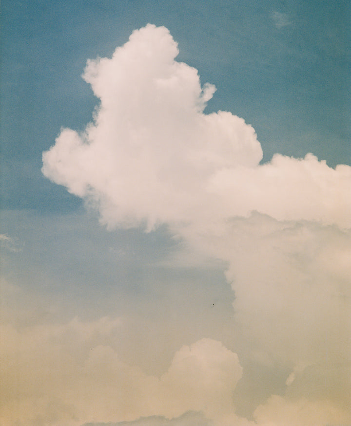 Image of puffy clouds in a blue sky.